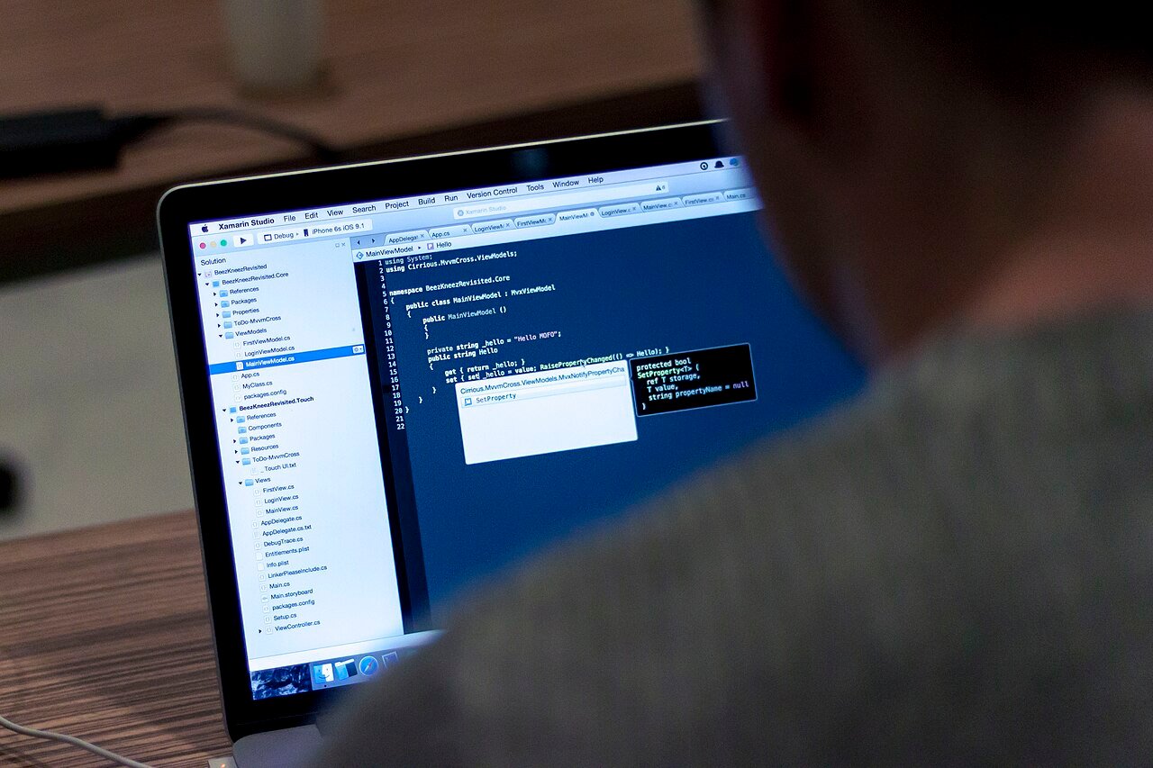 A developer working on code on a laptop